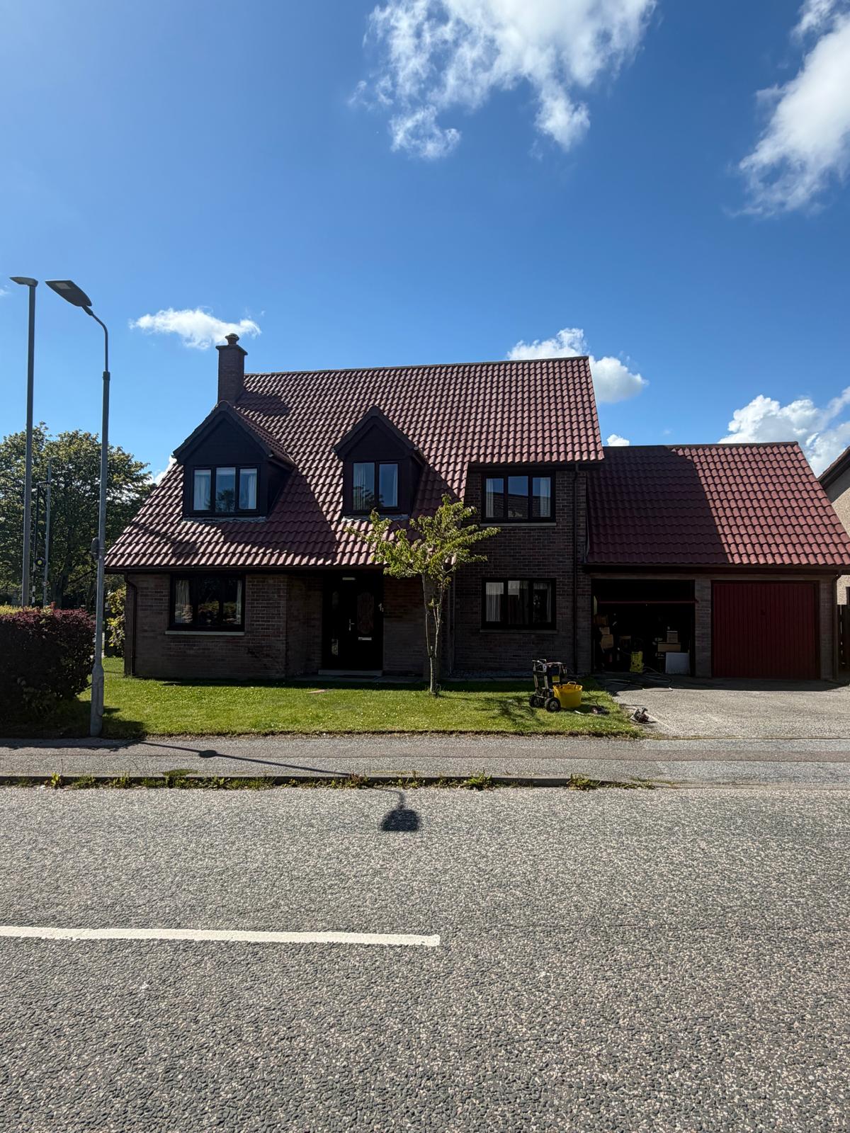 Completed roof cleaning job on a detached property