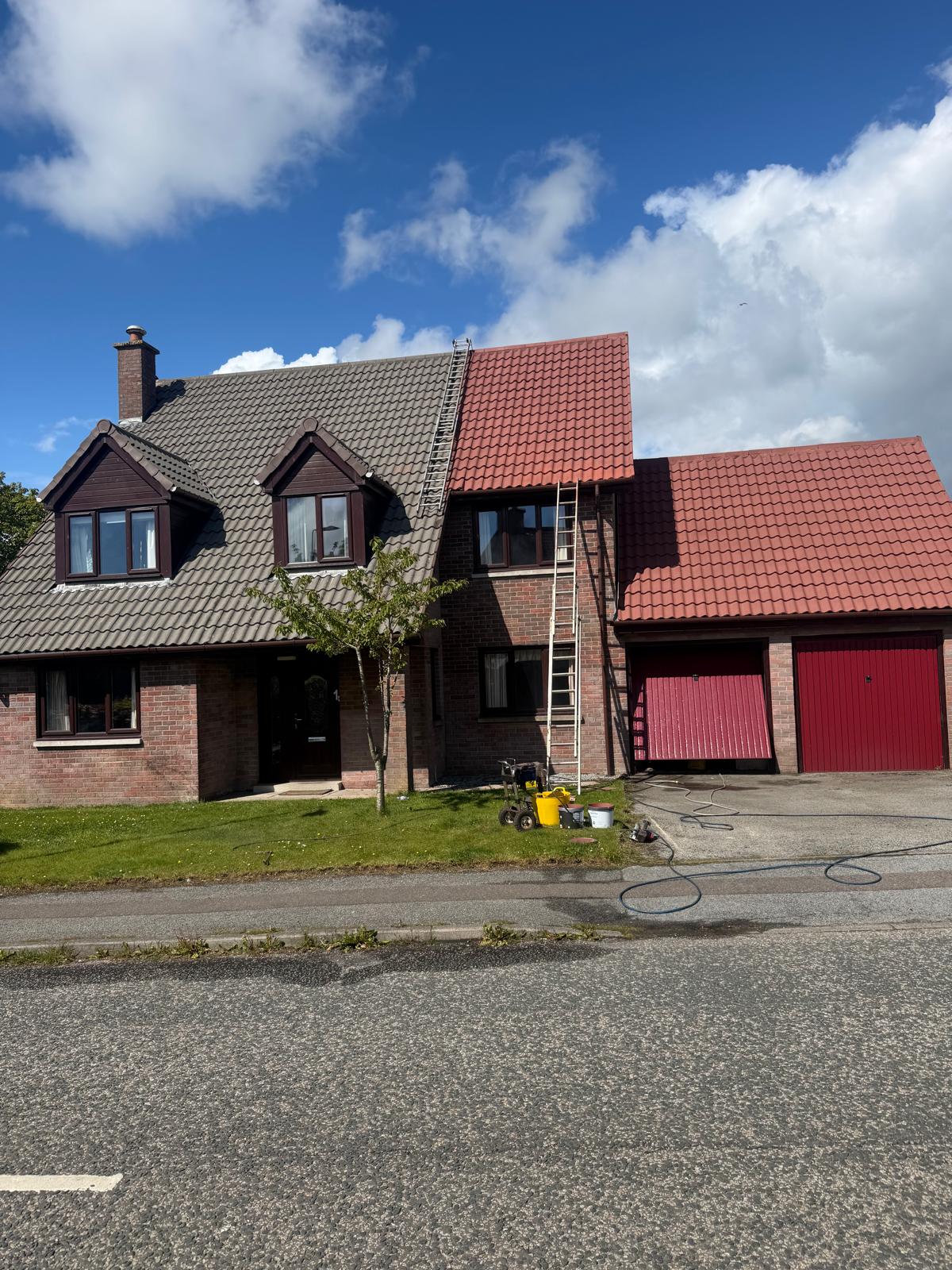 Roof cleaning in progress with ladder and equipment