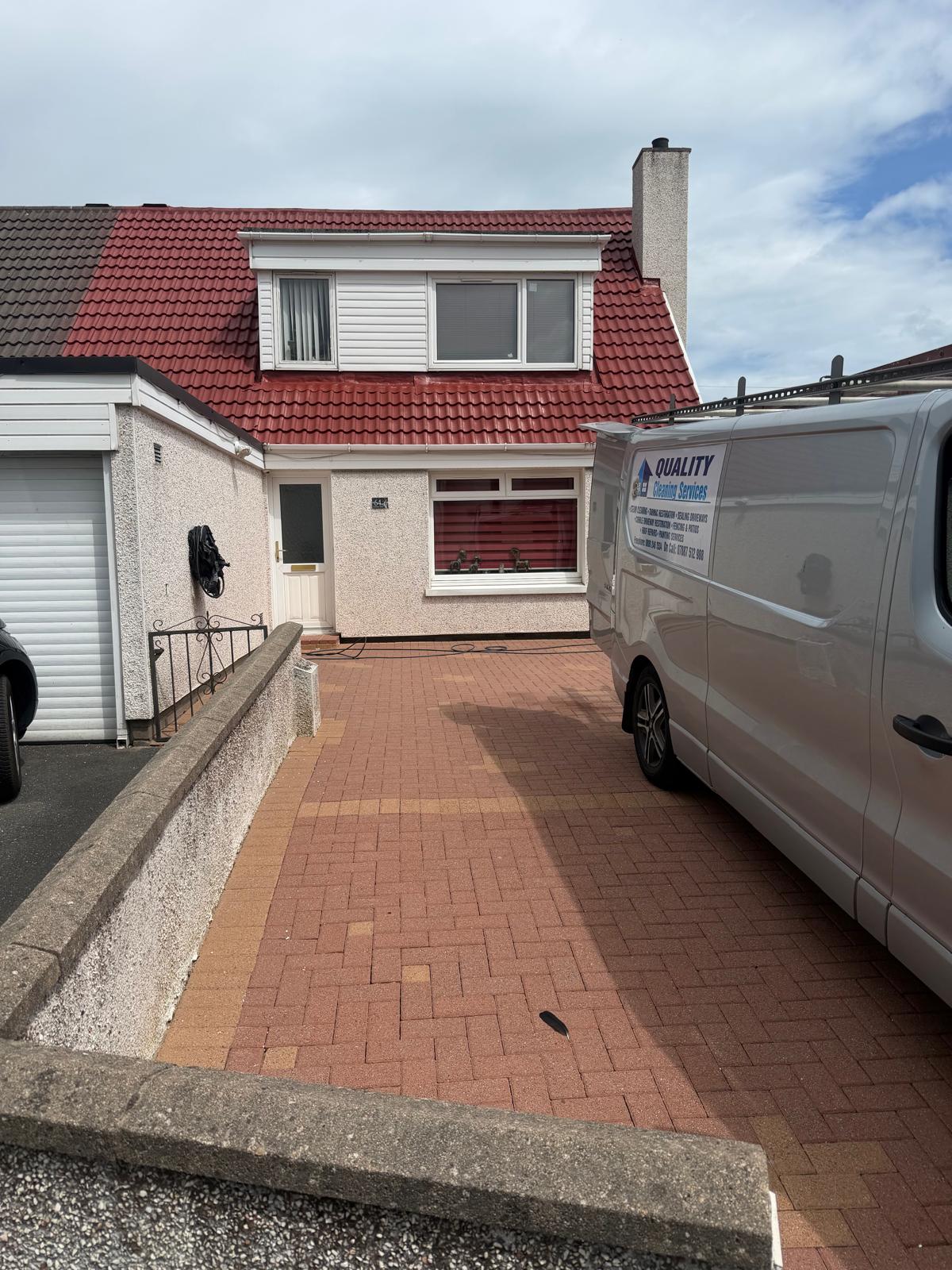 Semi-detached house with freshly cleaned red roof tiles